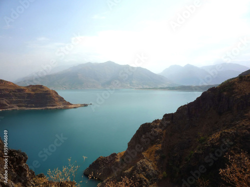 Beautiful lake Charvak, with blue water in the mountains of Uzbekistan. Beautiful lake on the background of mountains.