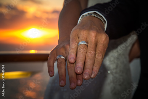 Rings sunset - Wedding couple wear rings on the right hand  photo