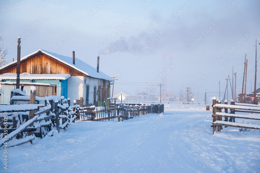 Winter landscape of the village Oymyakon with traditional wooden houses and smoke from the chimneys, one of the coldest permanently inhabited settlements on Earth, Sakha Republic, Russia, -48 °C Winter landscape of the village Oymyakon with traditional wooden houses and smoke from the chimneys, one of the coldest permanently inhabited settlements on Earth, Sakha Republic, Russia, -48 °C