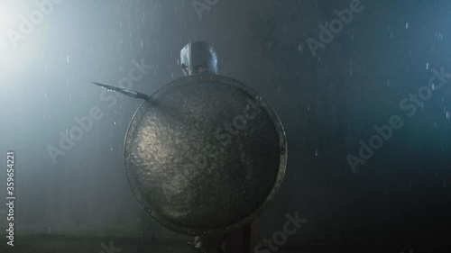 Muscular spartan fighting with spear.