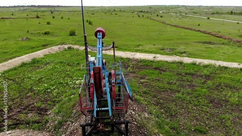 Oil pump jack rocking. Rocking machines for power generation. Extraction of oil. Aerial view.
