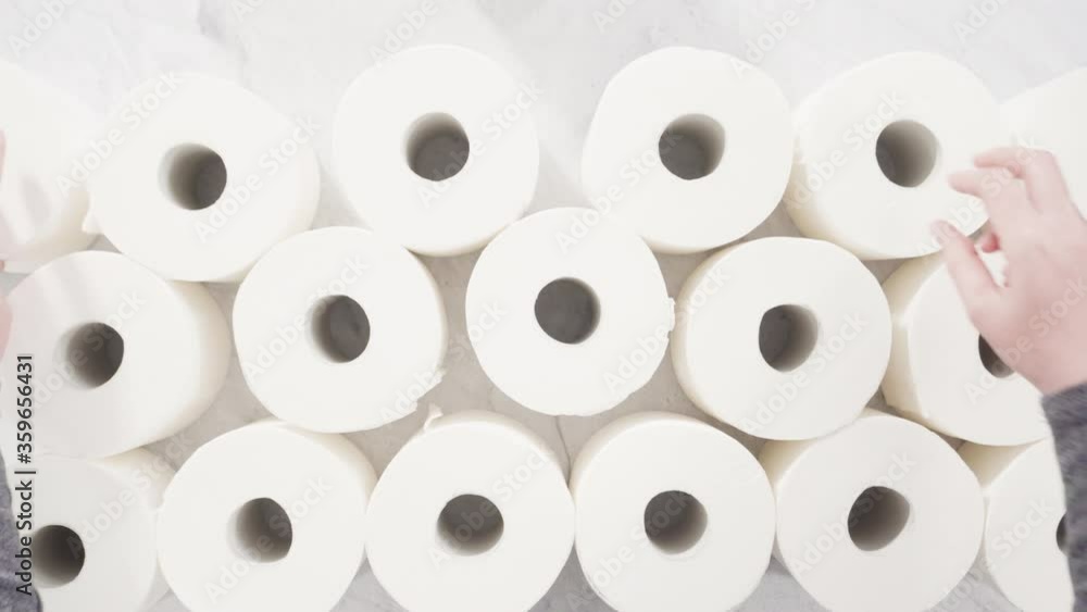 Flat lay. New white toilet paper rolls on a gray background. Flat lay. New white toilet paper rolls on a gray background.