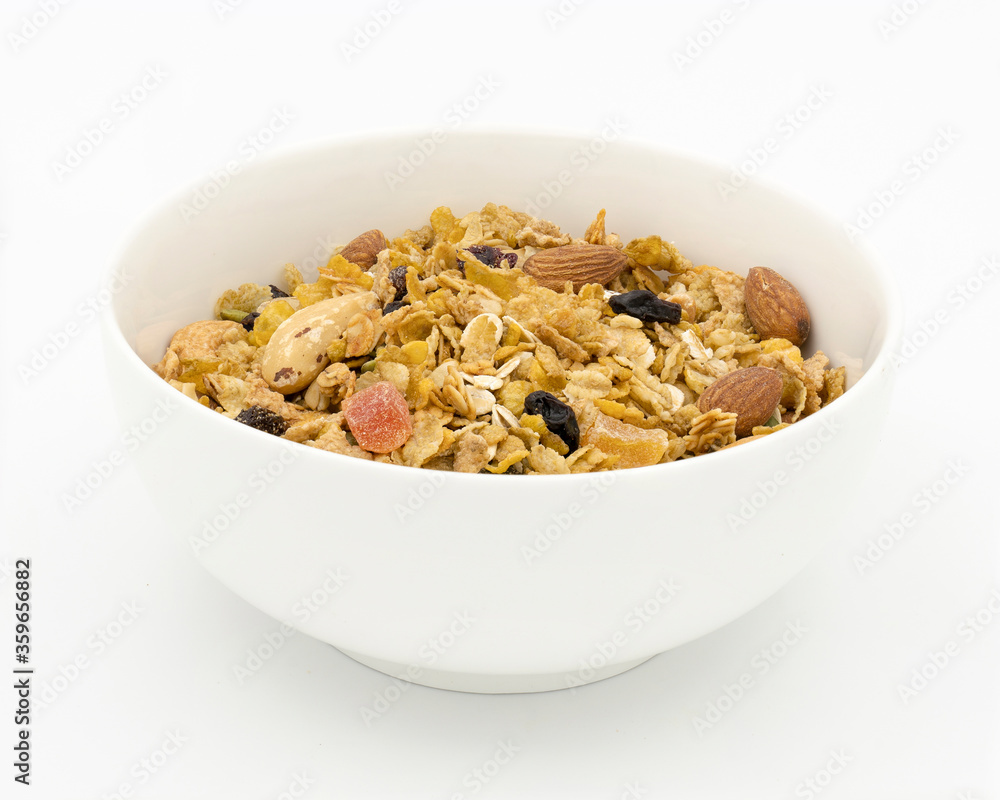 Bowl of granola with nuts, oats and raisins on white background Bowl of granola with nuts, oats and raisins on white background