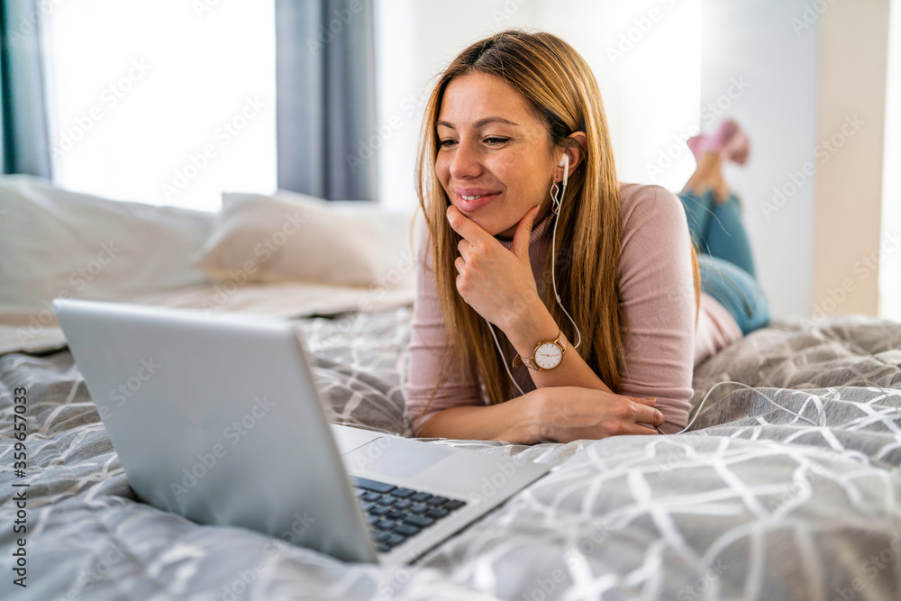 Beautiful young woman using laptop at home Beautiful young woman using laptop at home