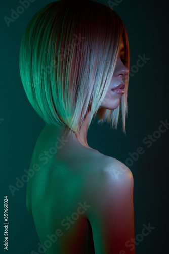 Murais de parede Asian woman in neon light. Beautiul blonde in night club