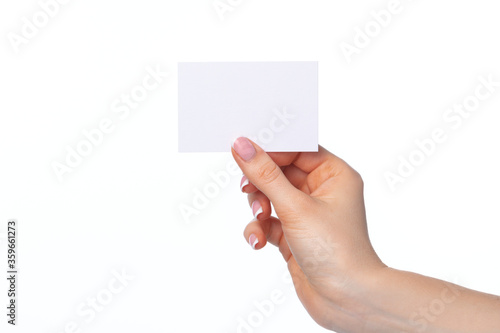 Female hand with blank white business card isolated on white
