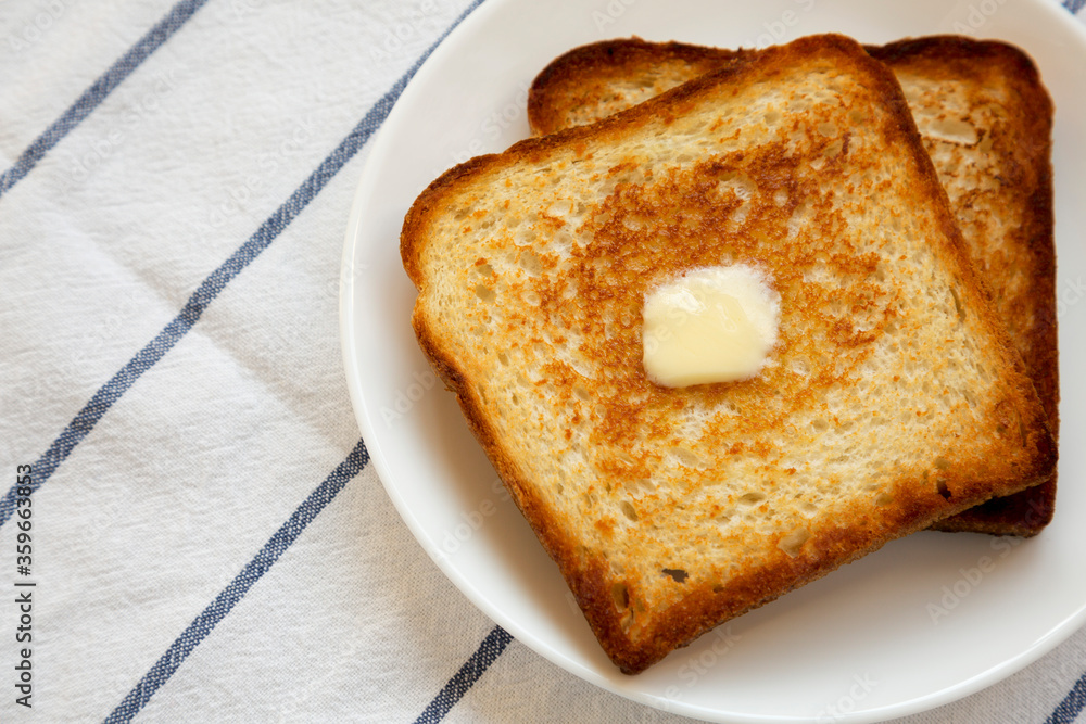 Homemade Buttered Toast on a white plate, close-up. Copy space. Homemade Buttered Toast on a white plate, close-up. Copy space.