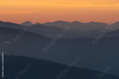 layers of mountains during sunrise