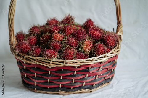 Red rambutans in a red basket 