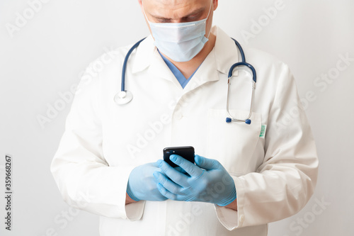 Male doctor using mobile phone. Online doctor. Telemedicine.