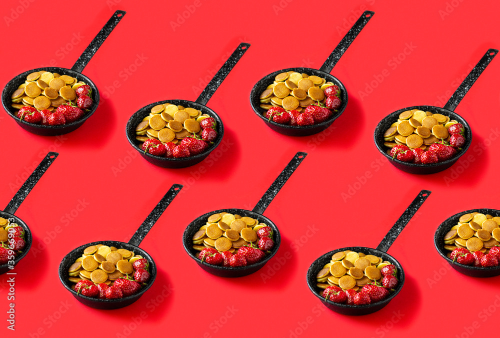 Trendy food - pancake cereal. Seamless pattern of Mini cereal pancakes with strawberries in pan on red background Trendy food - pancake cereal. Seamless pattern of Mini cereal pancakes with strawberries in pan on red background