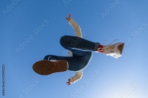 Jumping girl under the blue sky