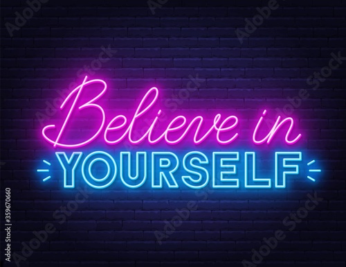 Believe in yourself neon quote on a brick wall. Inspirational glowing lettering.