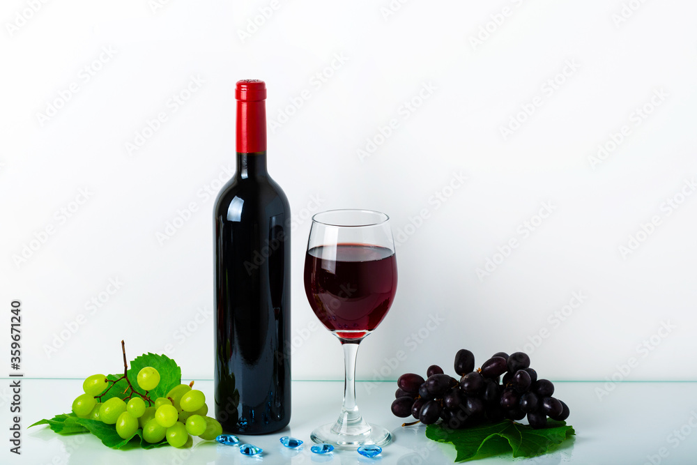 Still life with a glass of wine, glass and bunch grapes on white background in the hotel's bedroom. Home decor with copy space for your text.