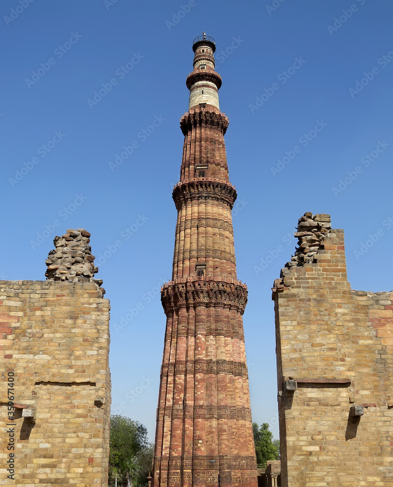 View of the highest in India minaret Kutub Minar - a vivid representative of Mughal architecture of the 13th century. New Delhi.