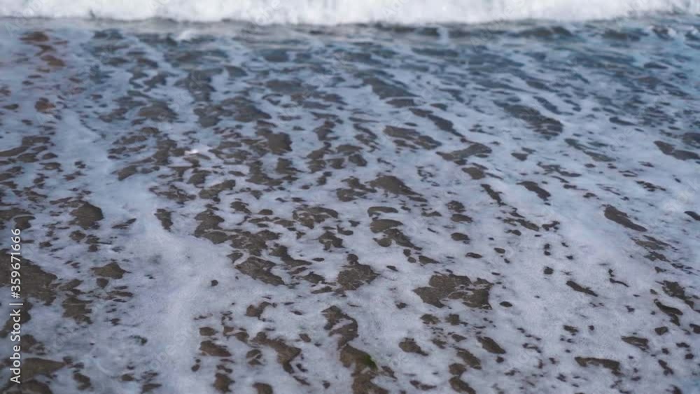 slow motion closeup big waves rolling on pebble sea public beach. slow motion closeup big waves rolling on pebble sea public beach.