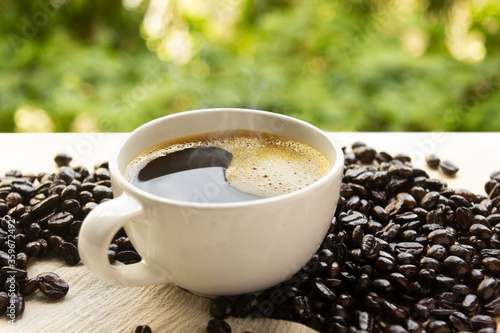 Hot coffee on wood table natural background soft focus