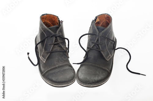 Old Black male shabby shoes isolated on white