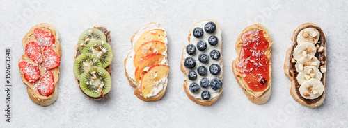 Sweet sandwiches with fruits and berries on white background.