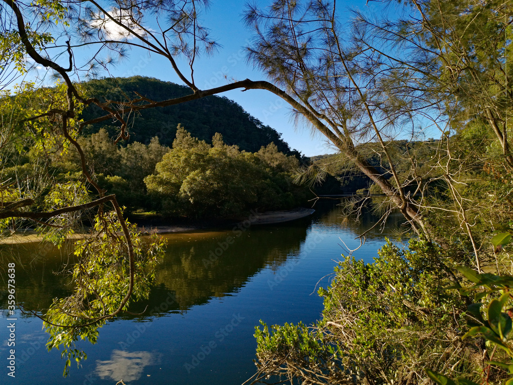 Creek with beautiful reflections of blue sky, mountains and trees, Crosslands Reserve, Berowra Valley National Park