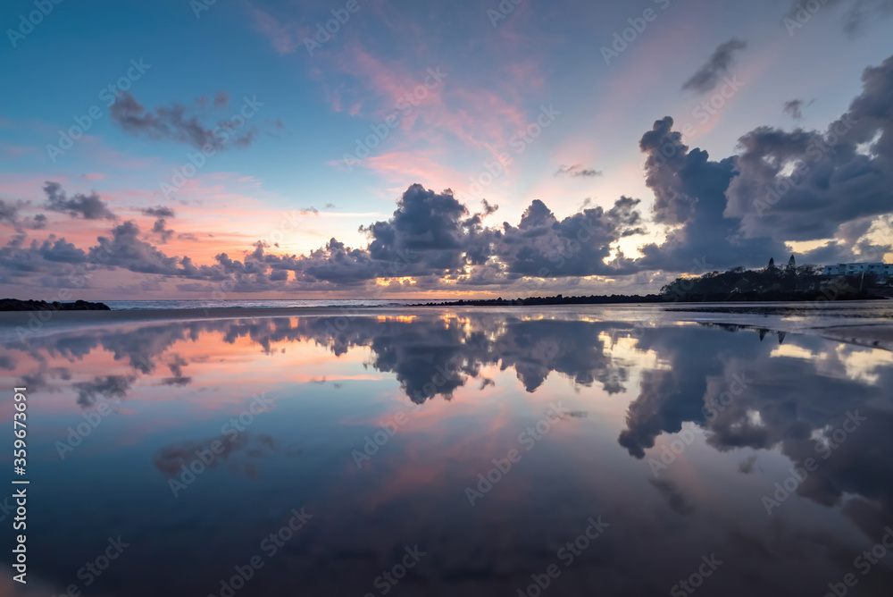 The morning clouds reflecting on the beach.