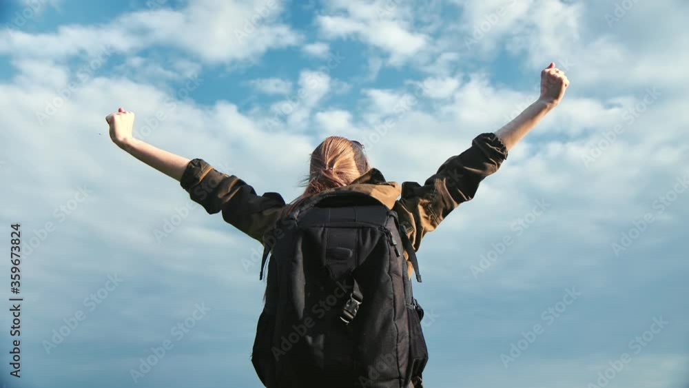 Travel woman with backpack making winner gesture at blue sky. Shot on RED Raven 4k Cinema Camera Travel woman with backpack making winner gesture at blue sky. Shot on RED Raven 4k Cinema Camera