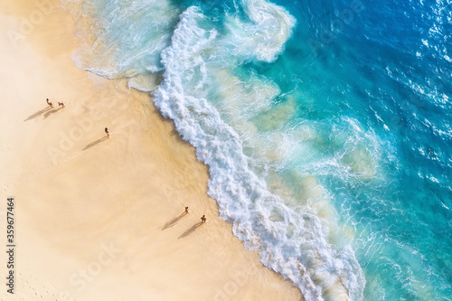 Beach, people and waves. Coast as a background from top view. Blue water background from drone. Summer seascape from air. Nusa Penida island, Indonesia. Travel - image © biletskiyevgeniy.com