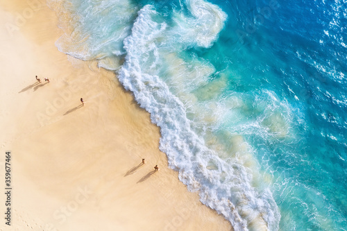 Obraz na płótnie Beach, people and waves. Coast as a background from top view. Blue water background from drone. Summer seascape from air. Nusa Penida island, Indonesia. Travel - image w salonie