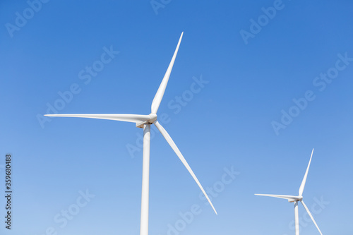 Propellers of the wind generator against blue sky