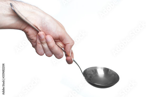 man hand holding soup ladle isolated on white background