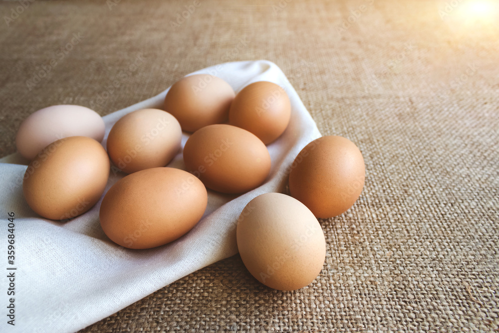 Close up of fresh organic chicken eggs from local farmer market on tablecloth, selective focus. World egg day and healthy, organic food concept. Copyspace for your text or presentation Close up of fresh organic chicken eggs from local farmer market on tablecloth, selective focus. World egg day and healthy, organic food concept. Copyspace for your text or presentation