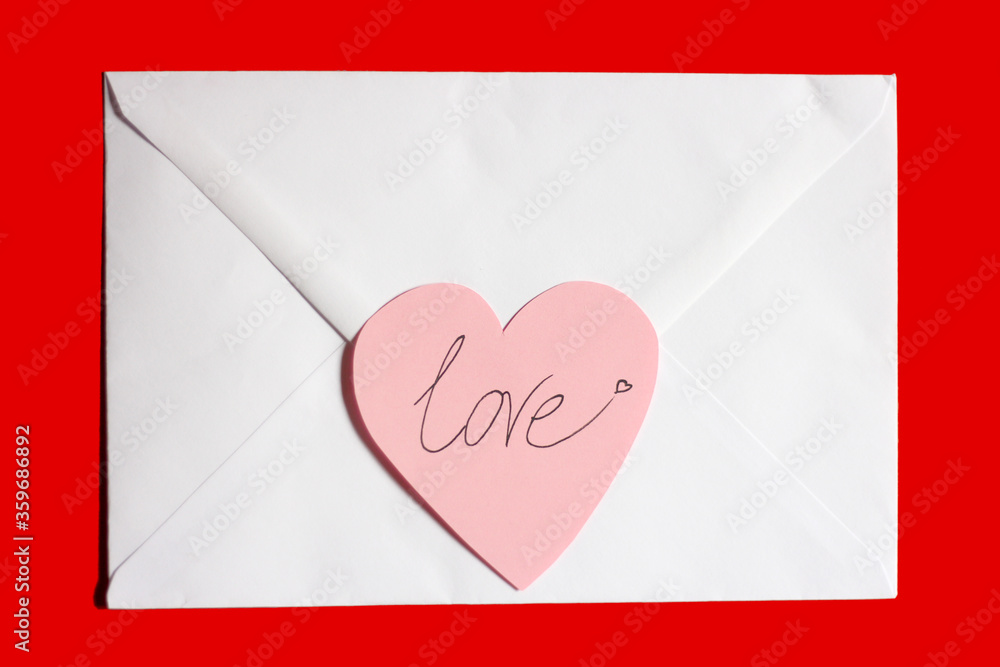 Valentine's day, love letter, white envelope with pink paper heart and text 