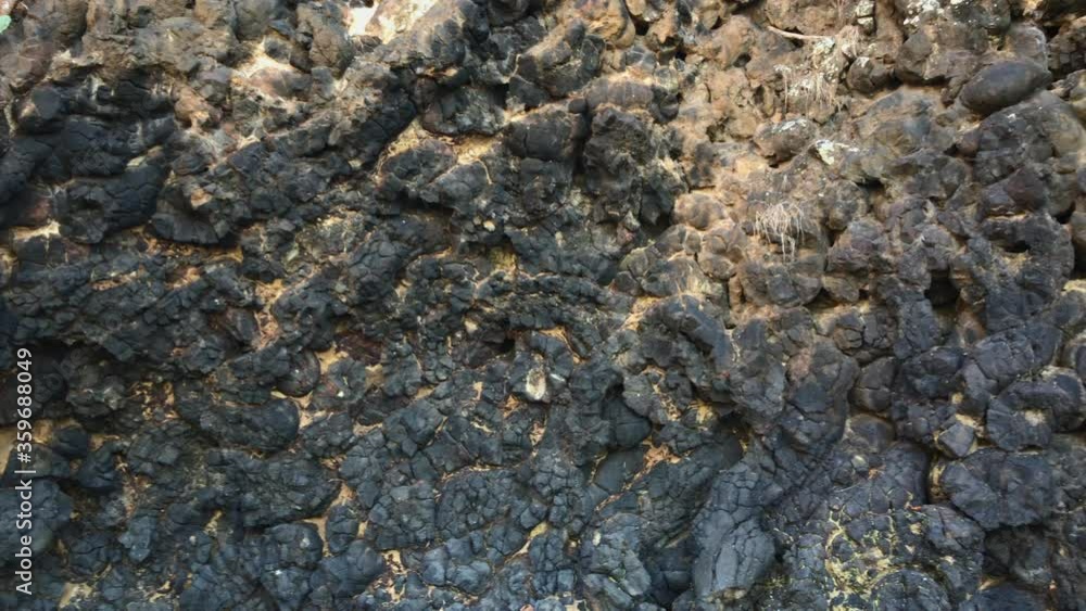 Black volcanic rocks on the Bali island. Shot on a phone Black volcanic rocks on the Bali island. Shot on a phone