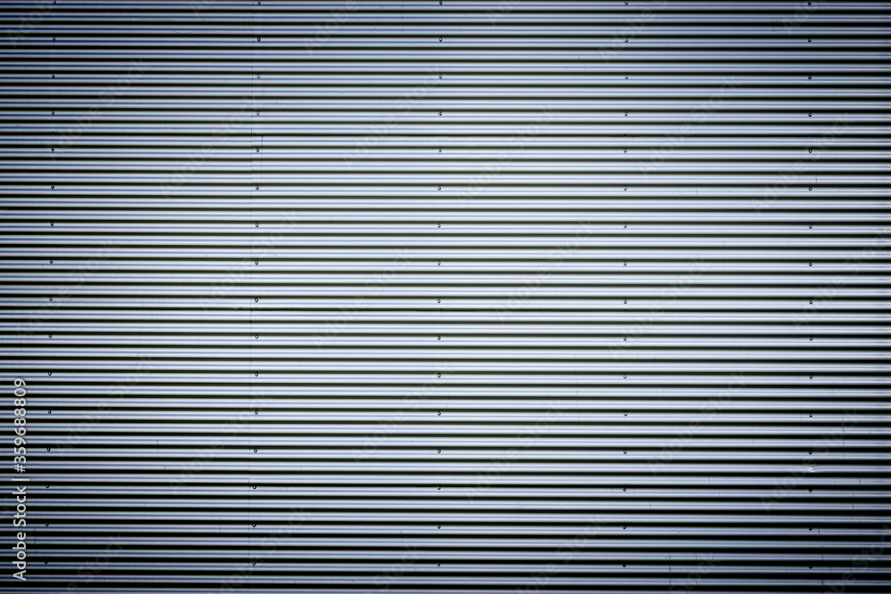 Corrugated metal sheet. New and Modern silver grey background pattern with nice vignetting. Corrugated metal sheet. New and Modern silver grey background pattern with nice vignetting.