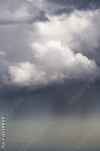 rain clouds hanging over the sea © SearchingForSatori