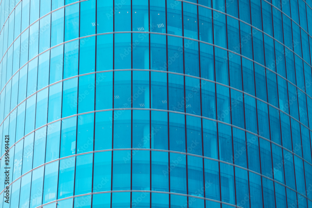 Modern facade of a skyscraper made of glass windows with blue toned. Modern facade of a skyscraper made of glass windows with blue toned.