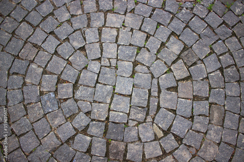 Top view dark square stones stacked on the ground in a circle.Stone background.