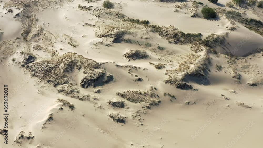 Drone flight over sand desert. Aerial view of dry sand hill dunes and sandy landscape.