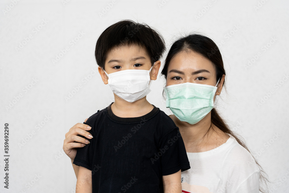 portrait woman and her son waring mask for protect corona virus on white background.	