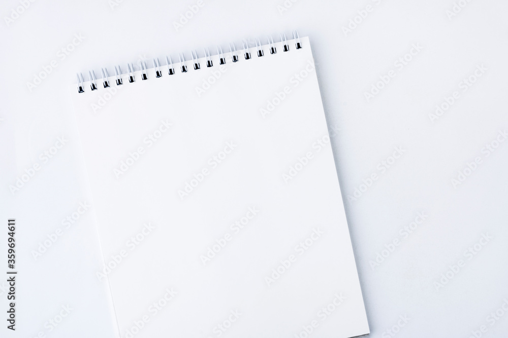 White open notebook. White notebook with spiral mount pages, on a white background. Copy space