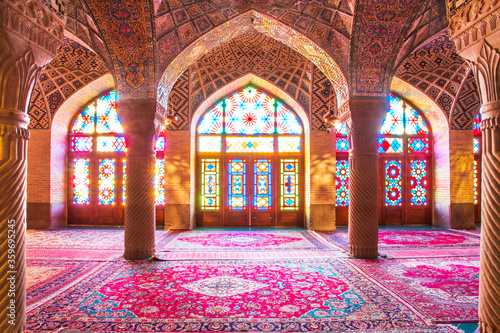 Quadro su tela Famous pink mosque decorated with mosaic tiles and religious calligraphic scripts from Persian Islamic Quran, Shiraz, Iran