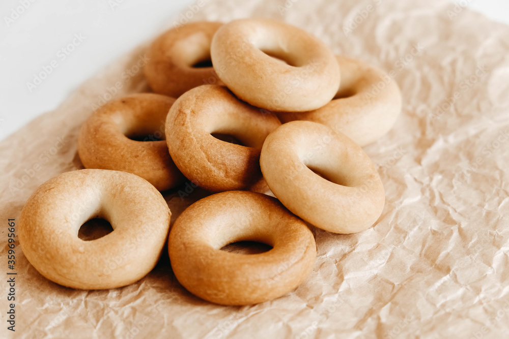 Drying or mini round bagels on kraft paper background. Copy, empty space for text