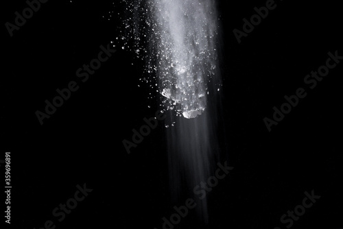 White powder explosion isolated on black background.