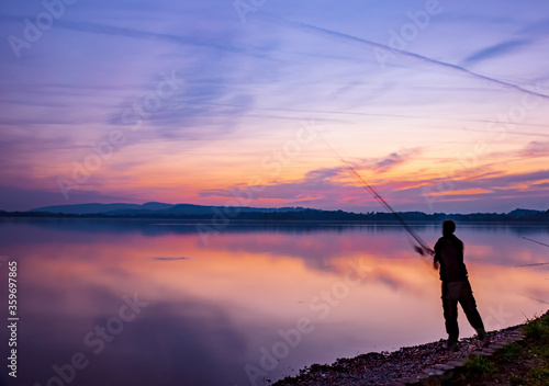 Fisherman at sunset on the Varese lake in Lombardy