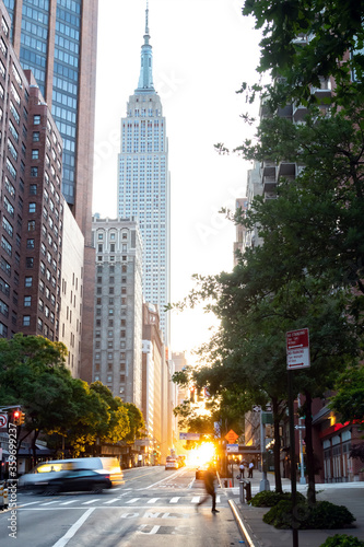 Sunset on 42nd Street in Midtown Manhattan with the light of sunset shining between the buildings of the New York City skyline