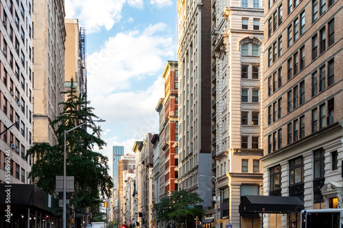 Sunlight shines on the buildings along Broadway through Midtown Manhattan, New York City