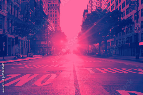 Photography View of an empty 14th Street in New York City with sunset shining between the bu