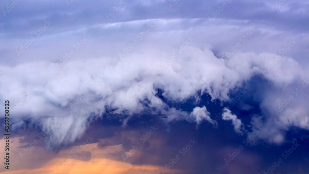 Dramatic storm clouds over city. Unusual clouds of different colors. Dark yellow sky before a thunderstorm. Selective focus, backlight, artificial noise, chrominance noise