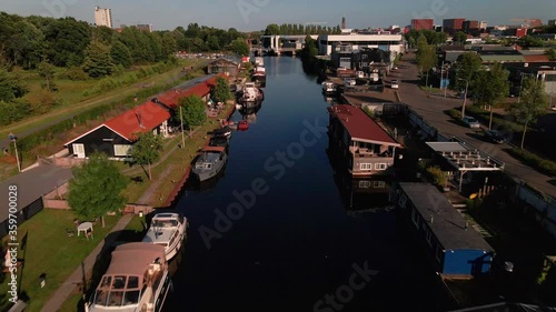 Aerial of river in the Netherlands. Leisure boats and living boats are docked at both sides photo