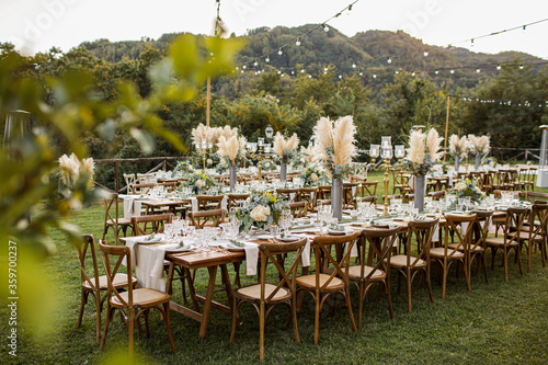 Wedding table set up in boho style with pampas grass and greenery